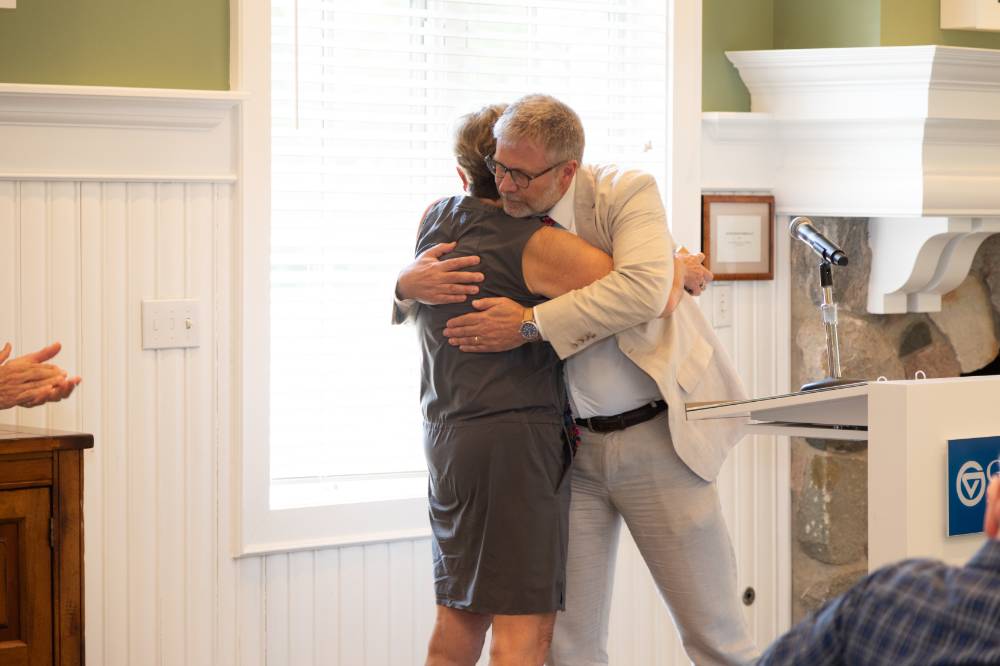Mark hugging Diane, a retiree